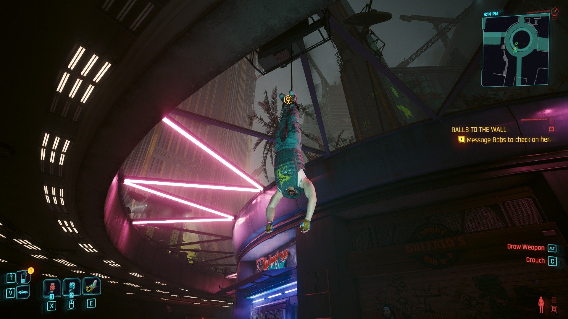 A headless corpse hanging upside down by a wire tied to its feet.