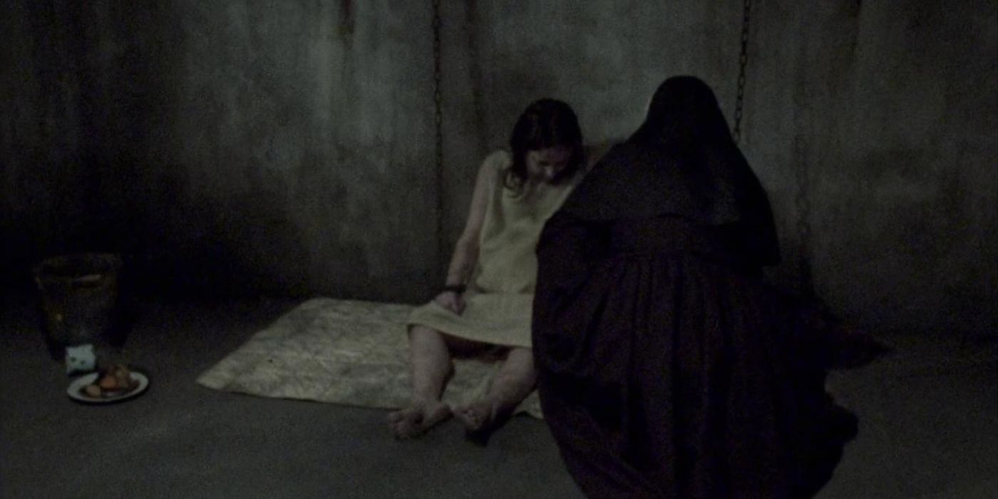 A veiled nun sitting next to a girl in The Devil&rsquo;s Doorway