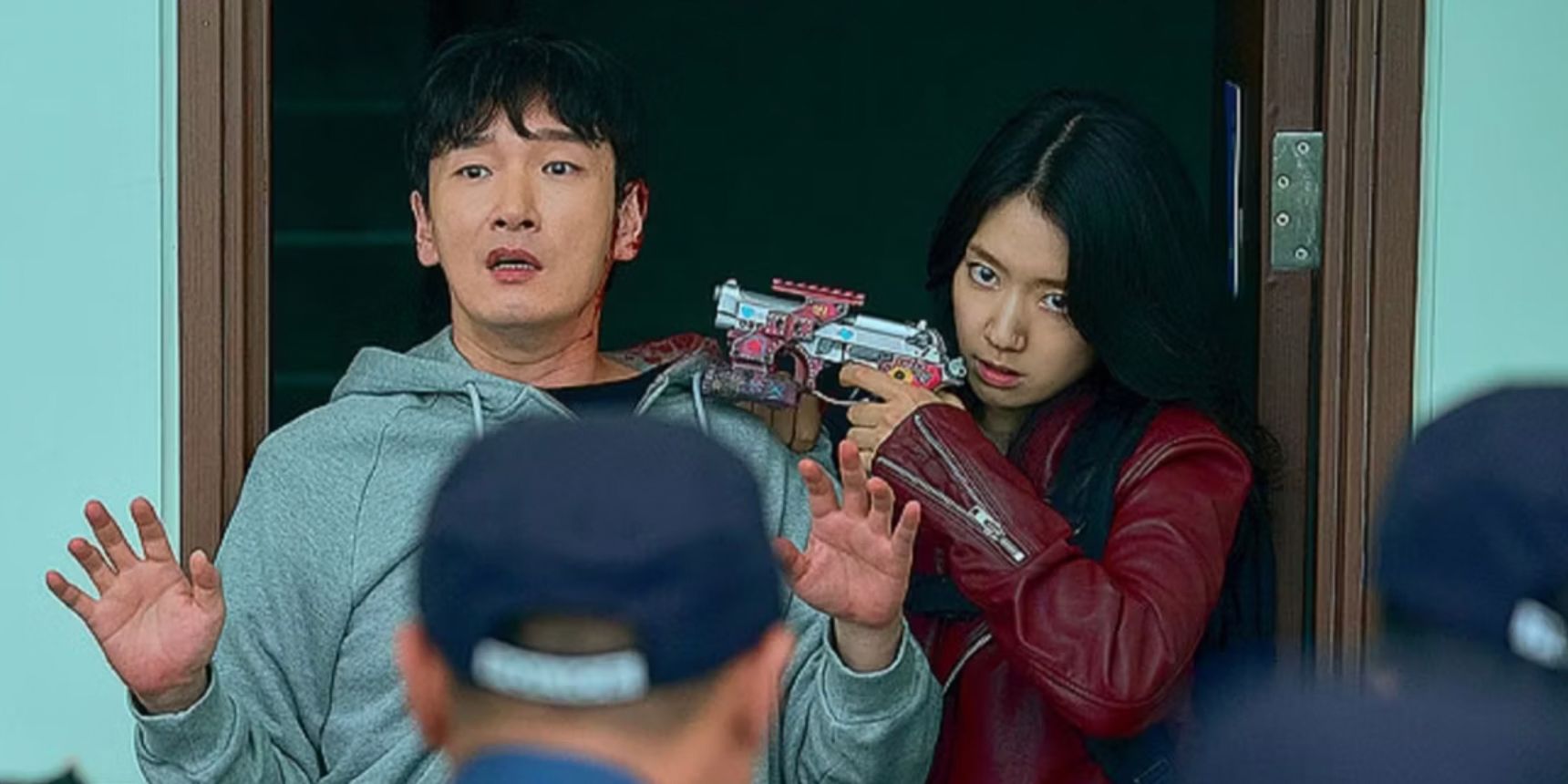A woman holds a gun on a man in the Korean time travel drama Sisyphus