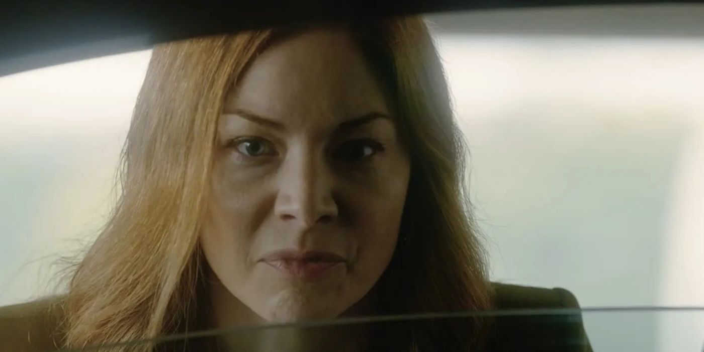 A woman looking angrily through a window in The Man with My Husband&rsquo;s Face.