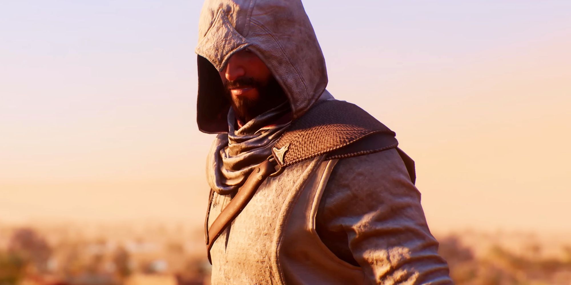 Basim in Assassin's Creed Mirage, with a pointed hood pulled down over his eyes. His robes are off white, and he's wearing a leather shoulder guard which has a strap going across his chest.
