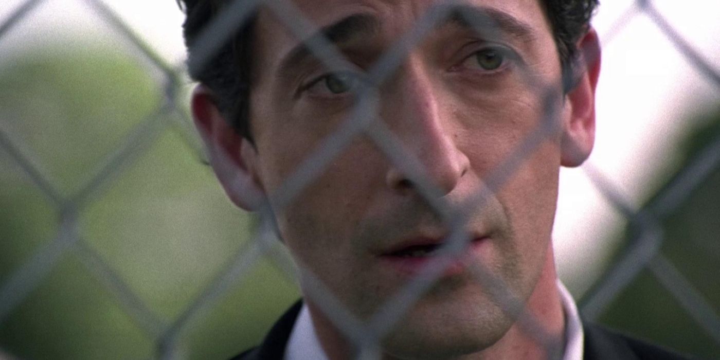 Adrien Brody looking through a fence in Detachment.