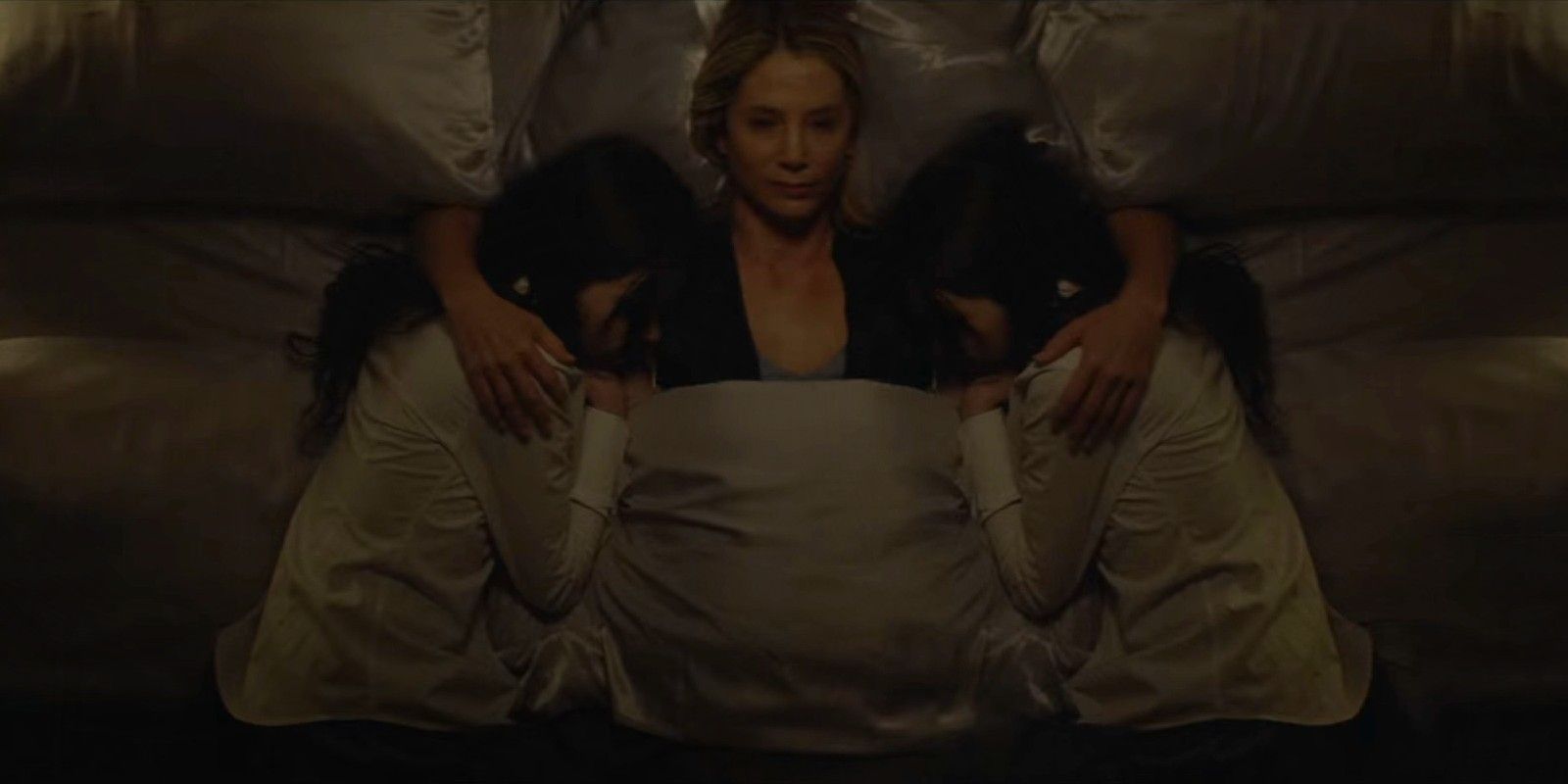 Amy lying with the twins in Look Away.