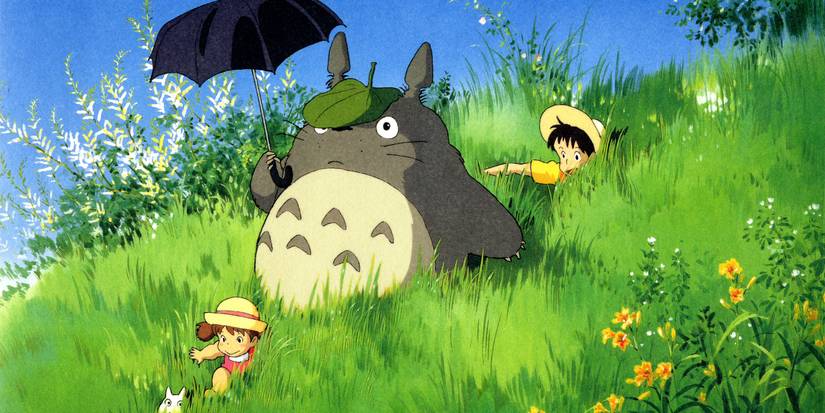Totoro, Mei, and Satsuki walking through a grass field in My Neighbor Totoro