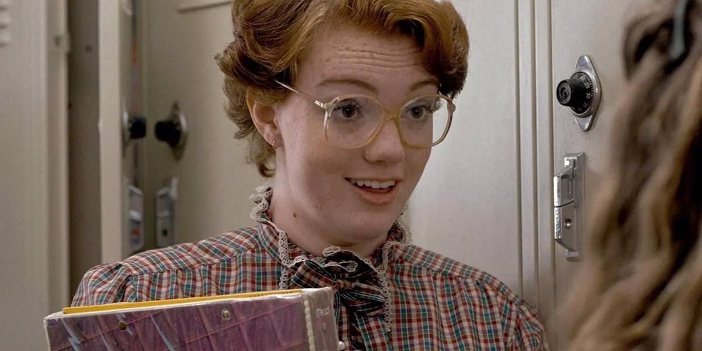 Barb holding a book in Stranger Things season 1
