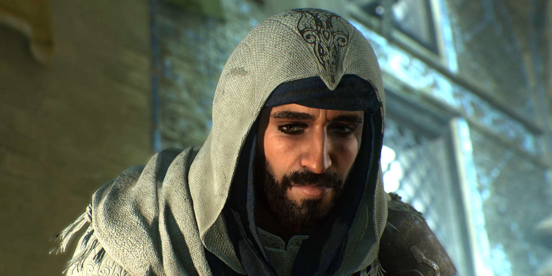 Basim crouching in a hooded Hidden Ones outfit in Assassin's Creed Mirage.