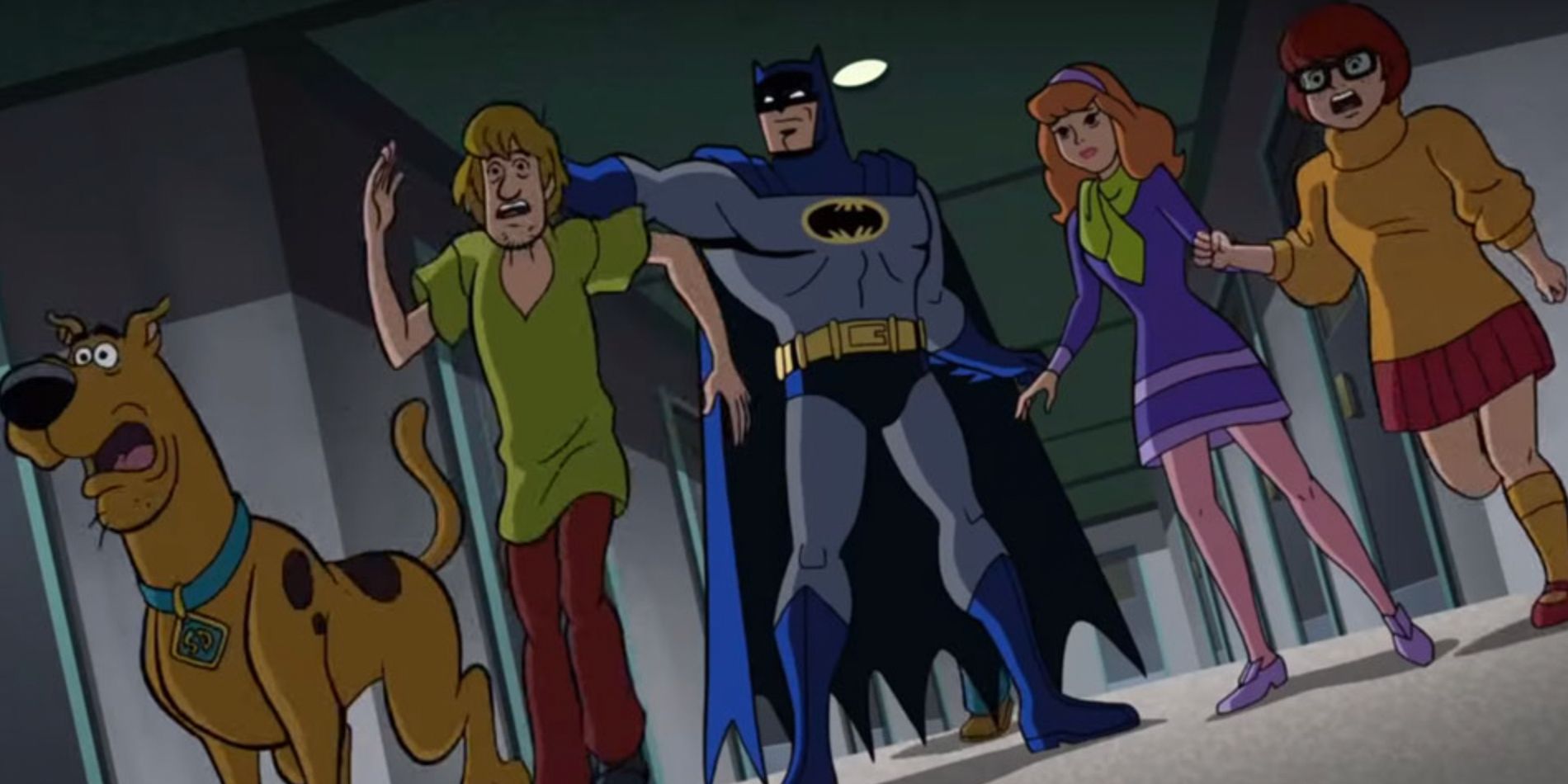 Batman holds onto Shaggy while the others are surprised in Scooby Doo and Batman The Brave and the Bold