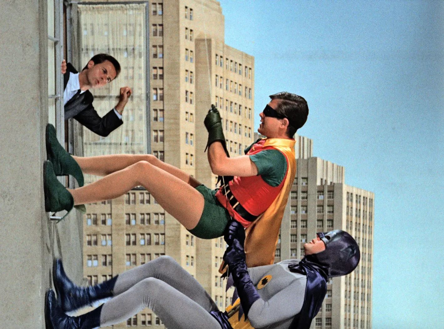 Burt Ward as Robin and Adam West as Batman in their classic &ldquo;climbing&rdquo; wall poses.