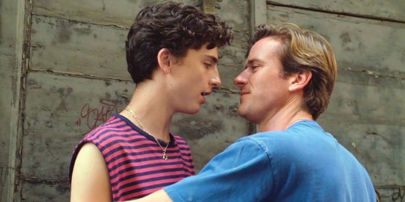 Timothée Chalamet as Elio and Armie Hammer as Oliver about to kiss against a wall in Call Me by Your Name