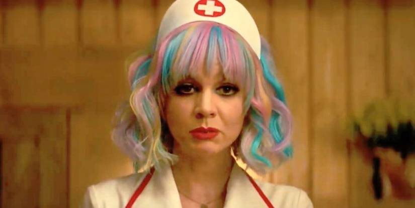 A closeup of Carey Mulligan in a nurse costume and multicolored wig in Promising Young Woman