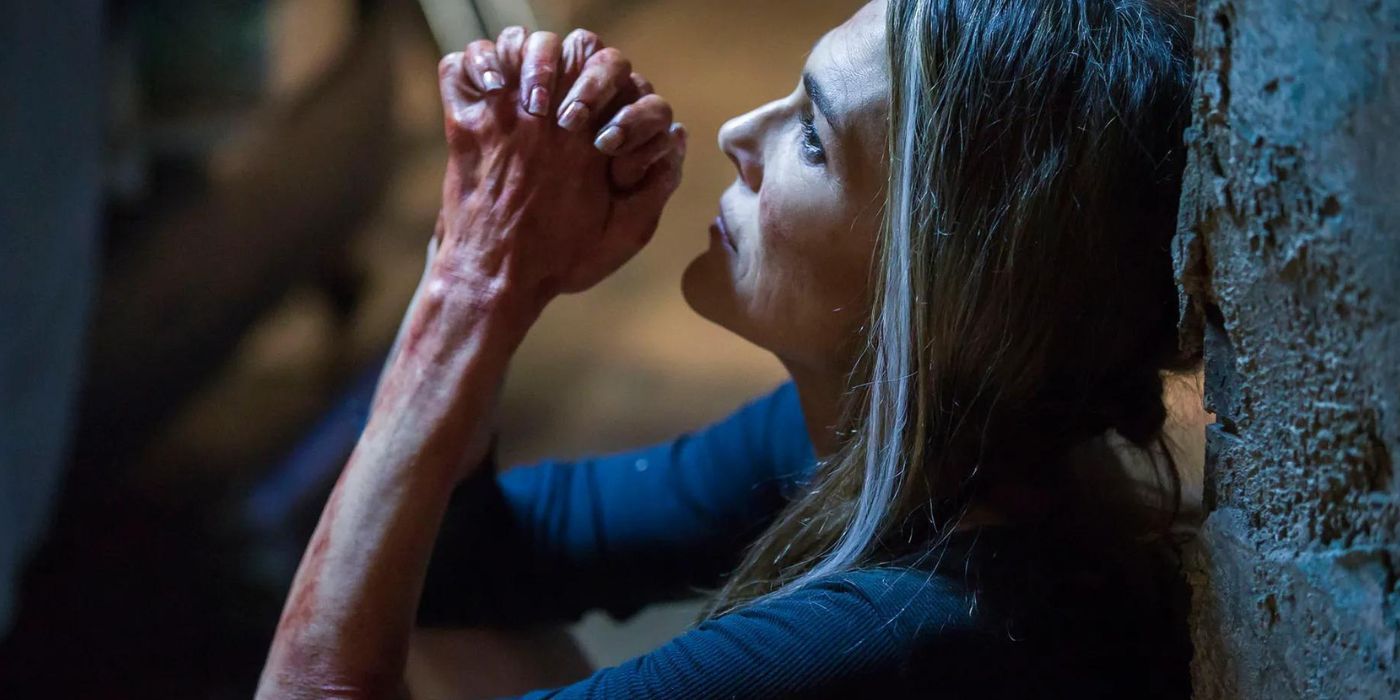 Paige Turko as Abby Griffin with her hands clasped seemingly in prayer in The 100