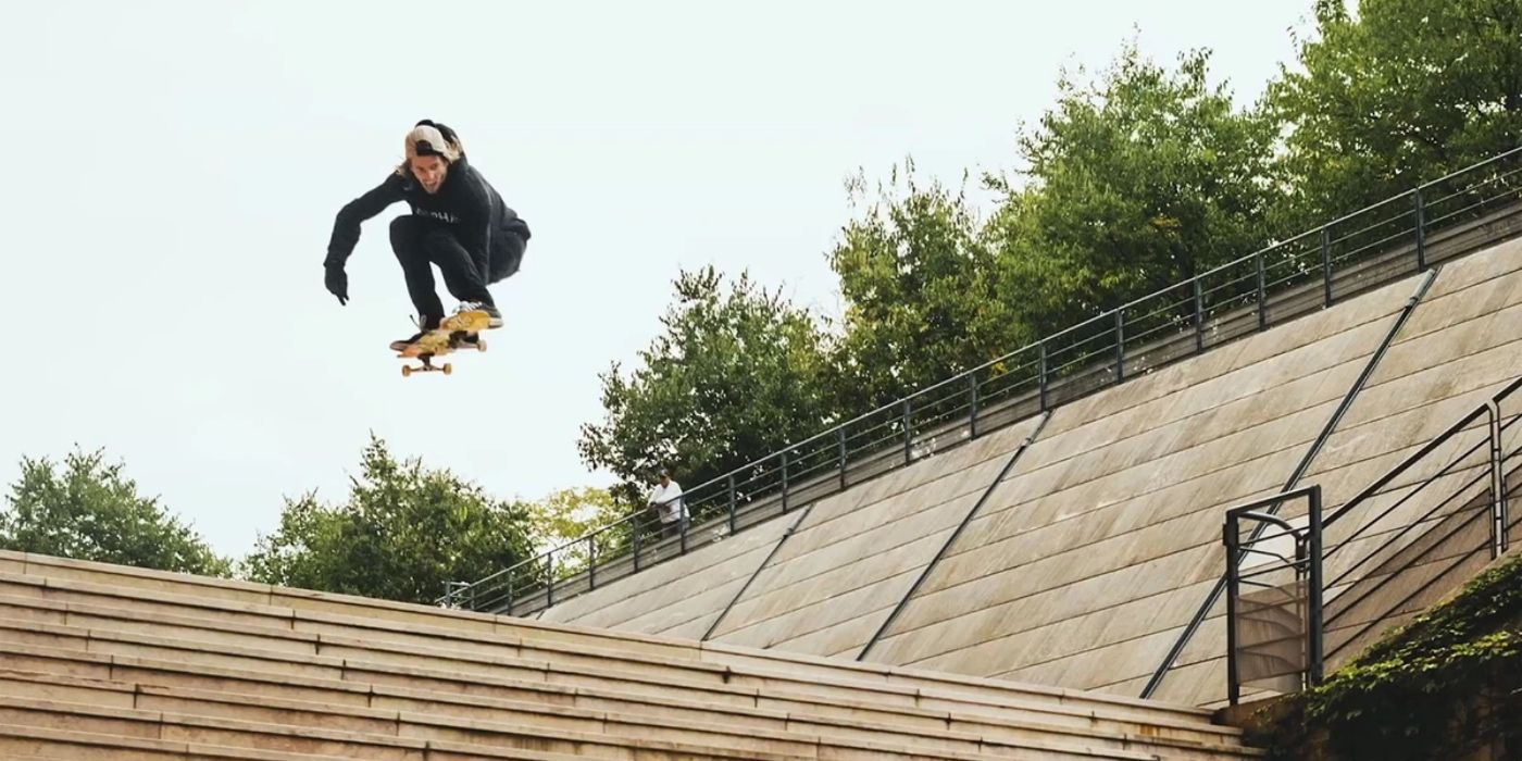 Aaron Jaws on a skateboard jump over a staircase