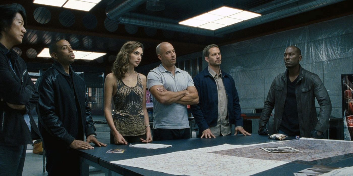 Dom's crew gathered at a table in Fast and Furious 6