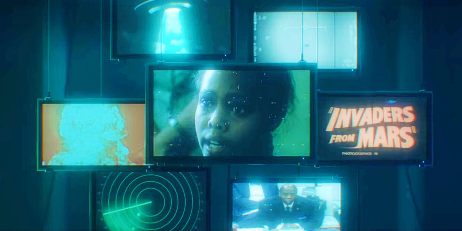 This screenshot from the Encounters introduction shows multiple TV screens with references to aliens and UFOs.