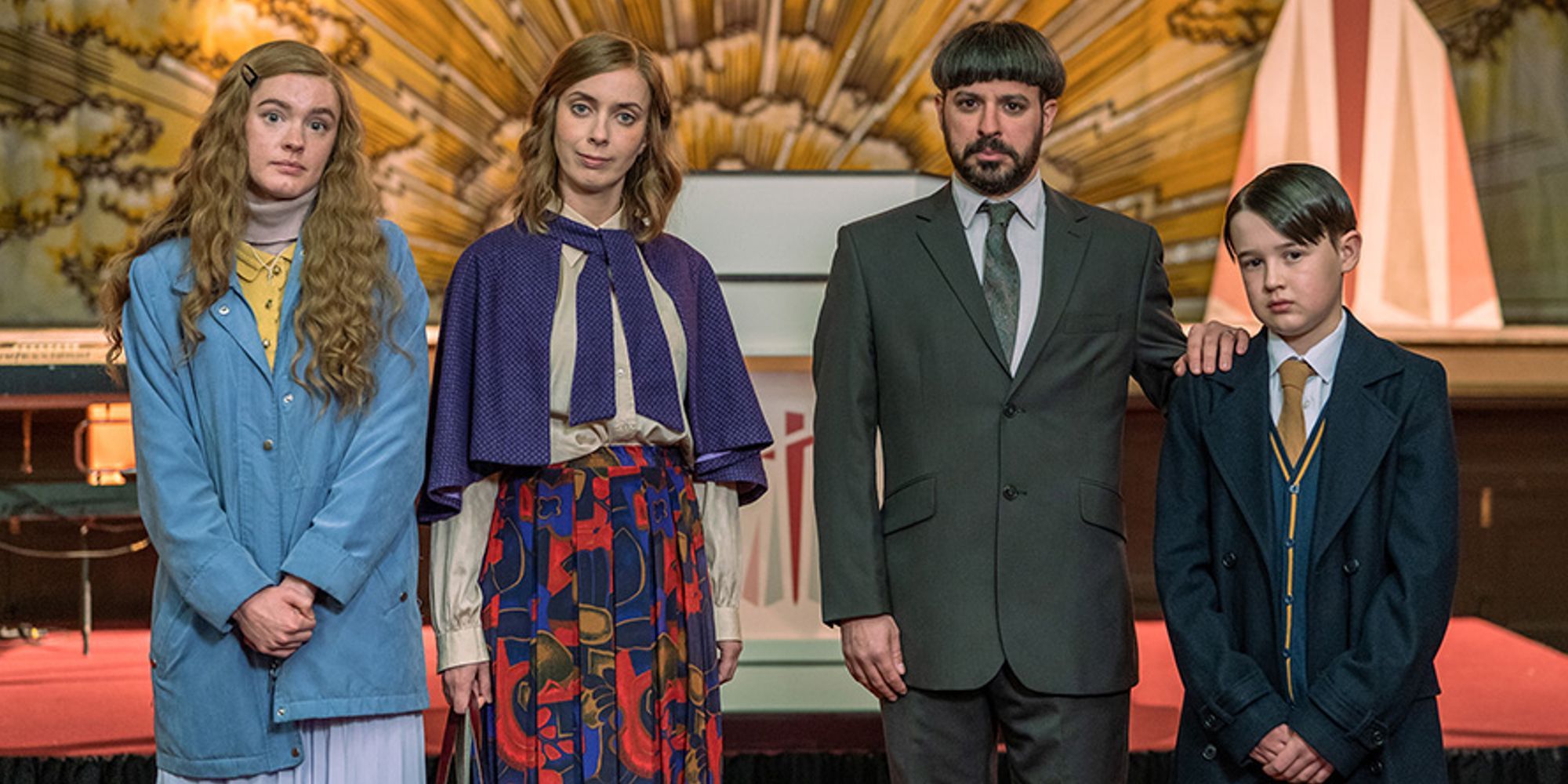 The family stands smugly in front of an altar looking at the camera in a promo image for Everyone Else Burns