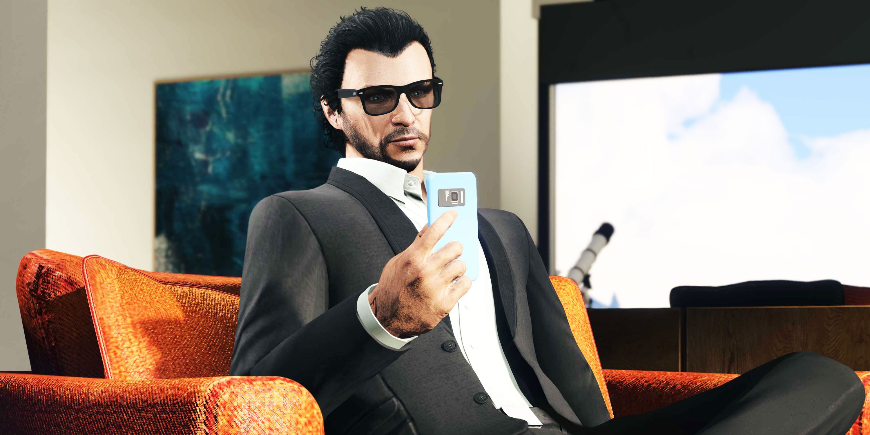 Man with sunglasses sitting on a couch and looking at his cellphone.