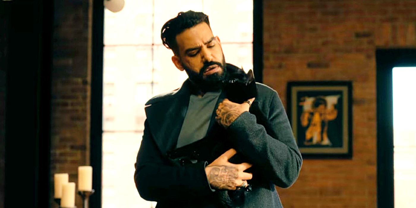 Rahul Kohli holding a cat as Leo in The Fall of the House of Usher 