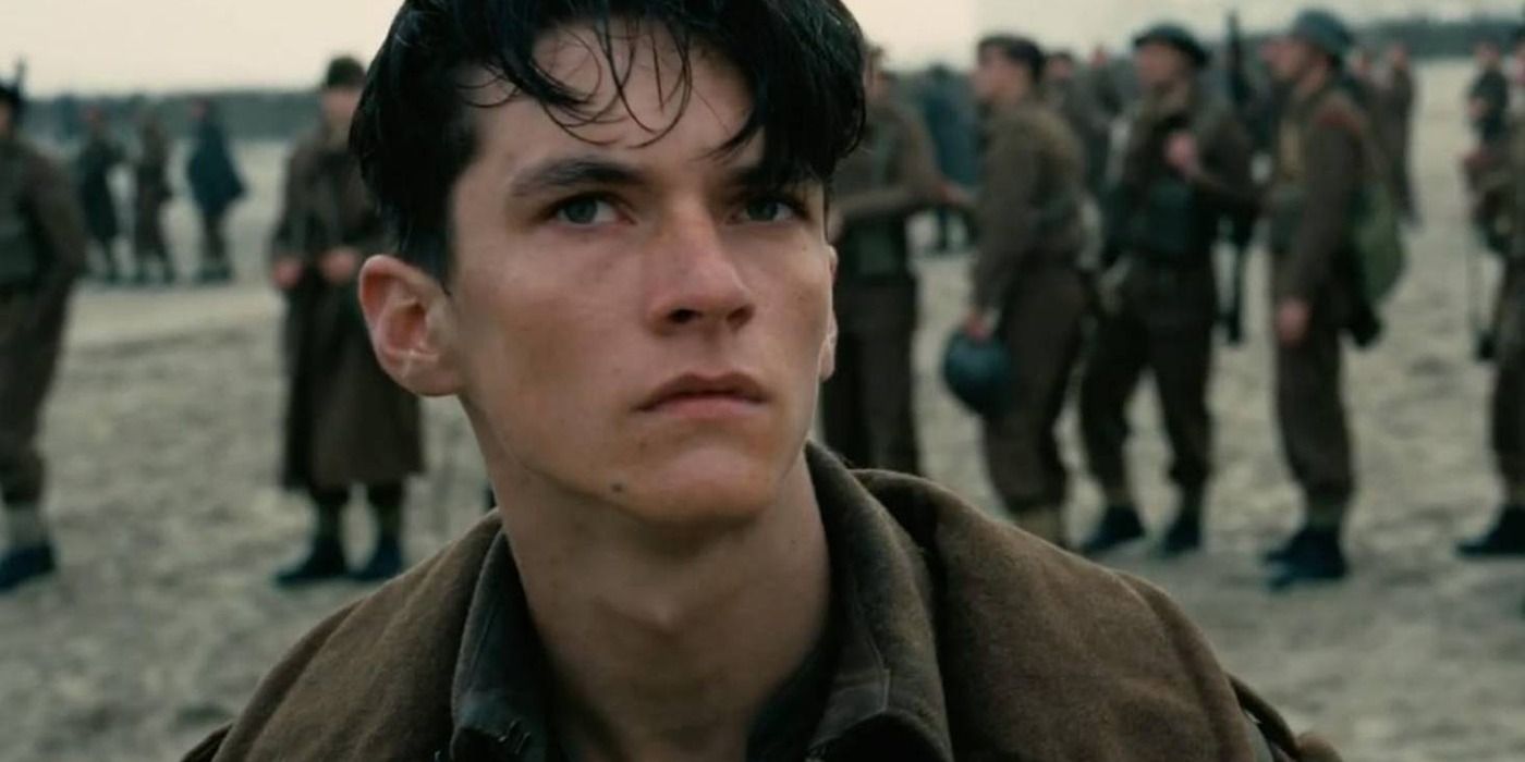 Fionn Whitehead looking up on a beach in Dunkirk