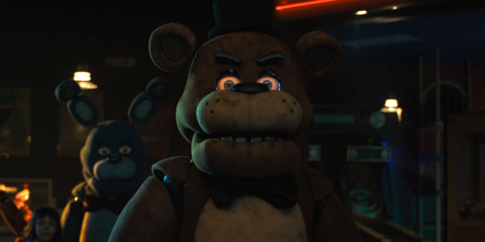 Freddy glares with glowing red eyes while Bonnie and Abby stand behind him.