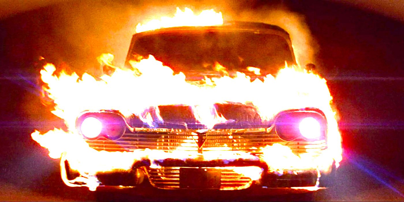 Christine the car drives toward the camera, flames leaping from its grille and hood.