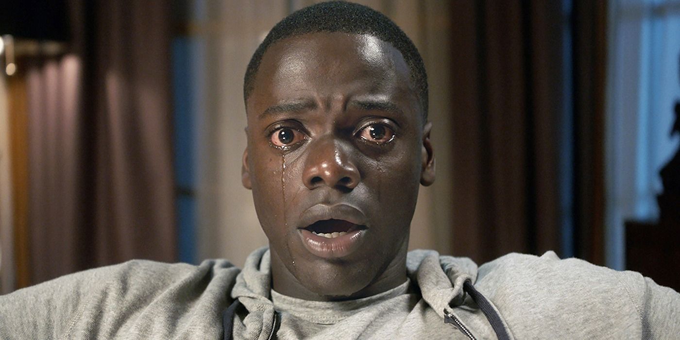 Chris (Daniel Kaluuya) staring ahead and in tears in Get out