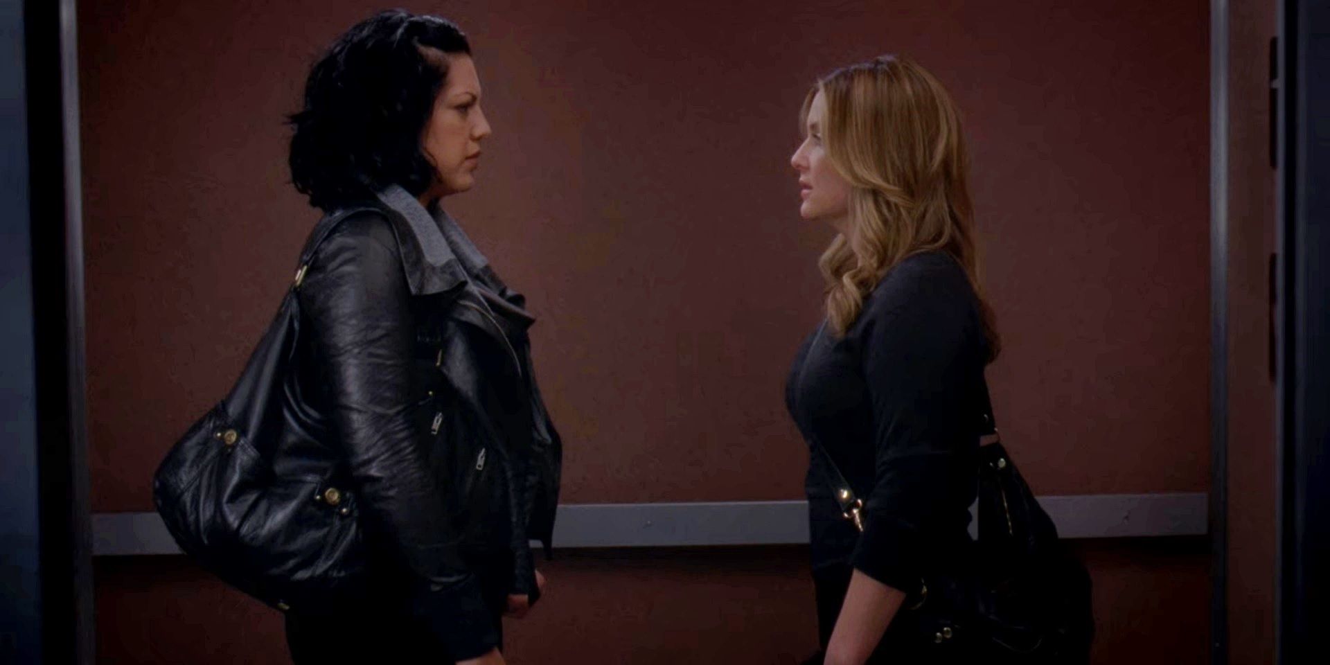 Callie and Arizona facing each other in an elevator in Grey's Anatomy season 7.