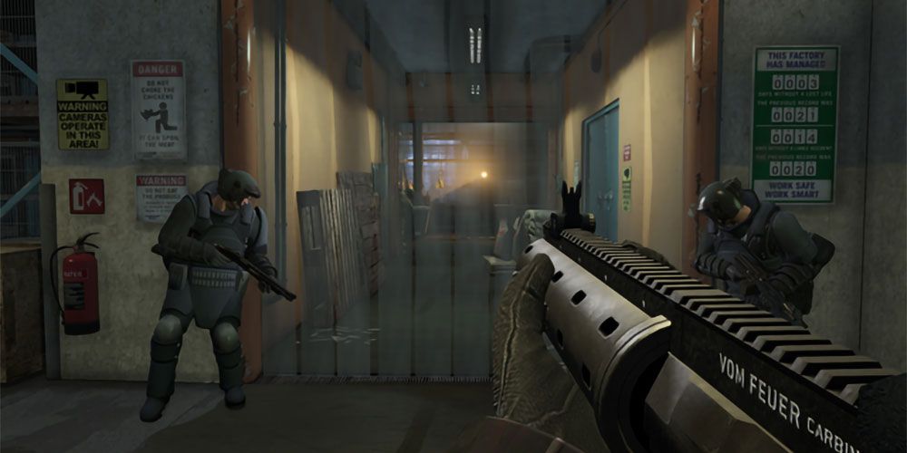 First person view of man with gun in a warehouse with SWAT members.