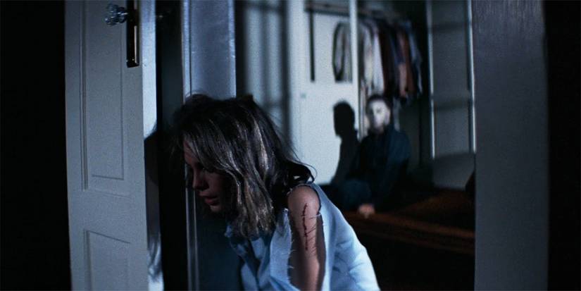 Jamie Lee Curtis as Laurie is injured while Michael gets back up behind her in Halloween 1978