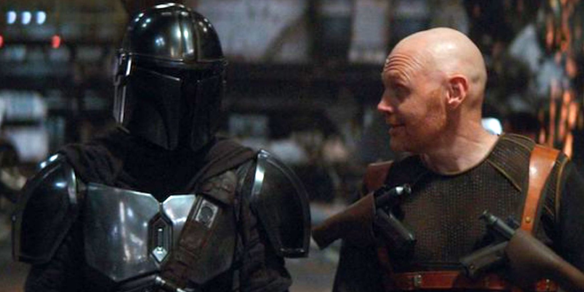 Din Djarin (Pedro Pascal) and Migs Mayfeld (Bill Burr) standing side by side in The Mandalorian season 1 episode 6