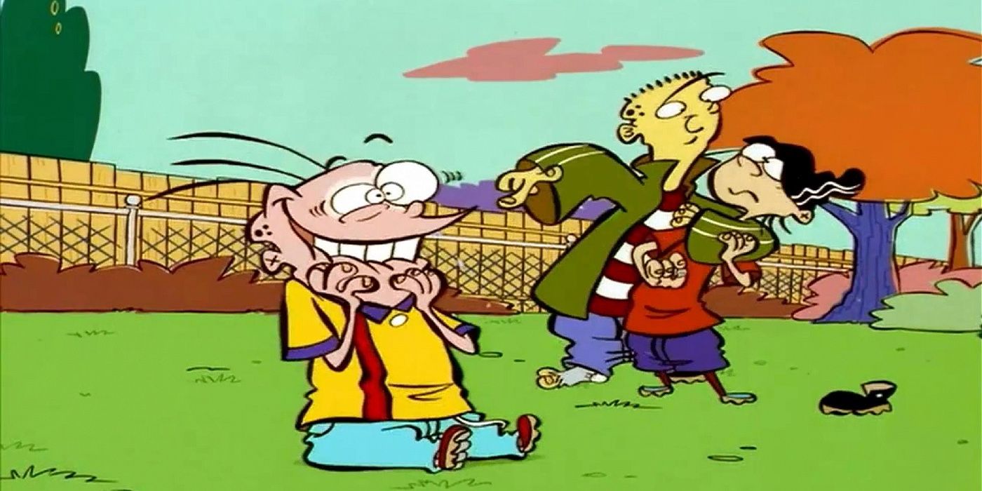 Eddy laughing on the grass, while Ed puts Edd in a headlock behind him in Ed, Edd, N Eddy.