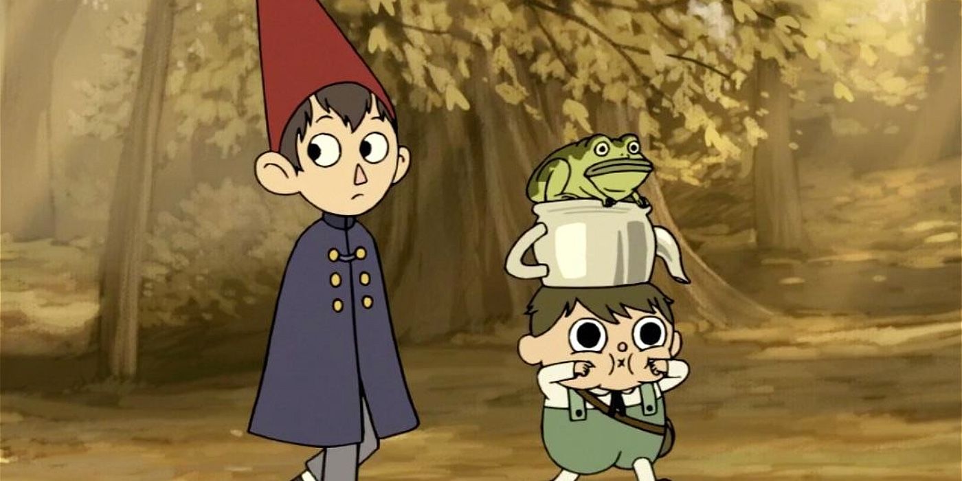 Wirt and Greg, who has a frog on his head, walk in the woods in Over the Garden Wall.