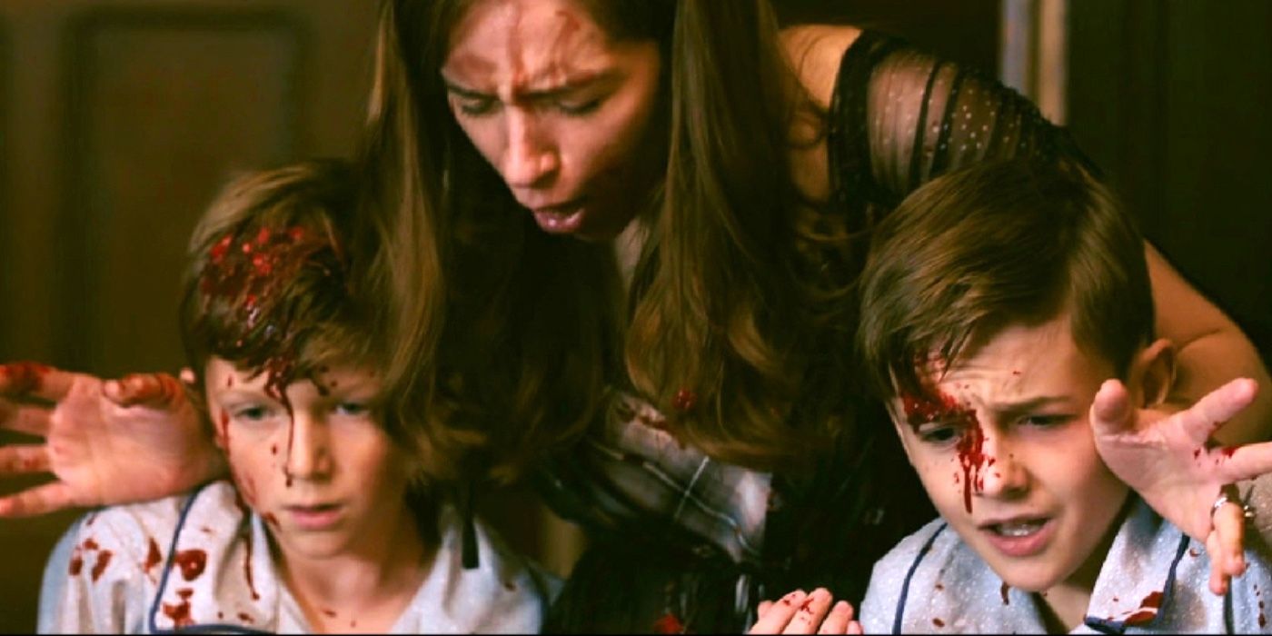 Georgie & Gabe Bradley with their mother's arms around them and blood on their face in Ready or Not.