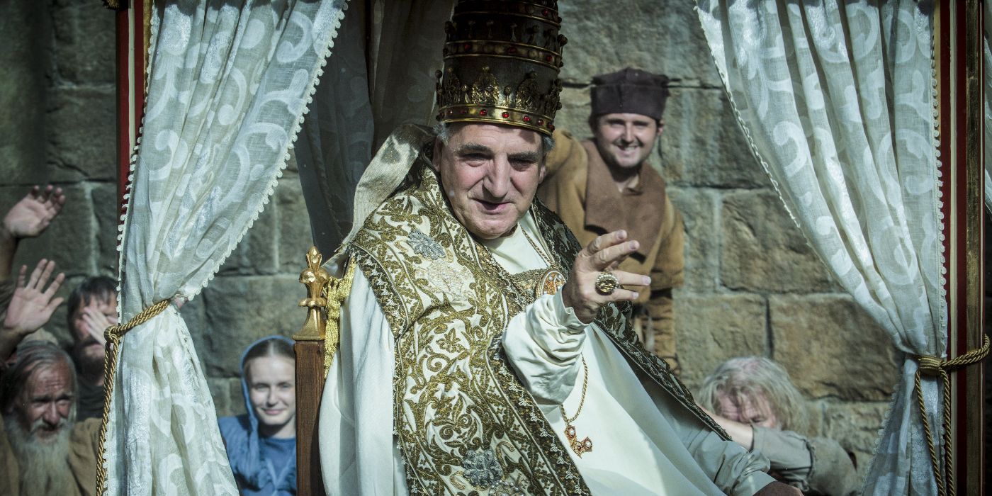 Jim Carter as Pope Boniface VIII waving in Knightfall.