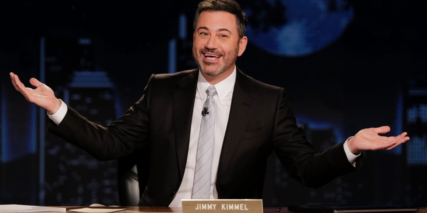 Jimmy Kimmel on his talk show with his arms outstretched