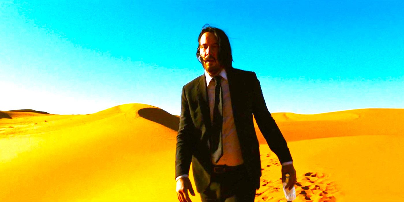 Keanu Reeves staggers across a sand dune in John Wick Chapter 3