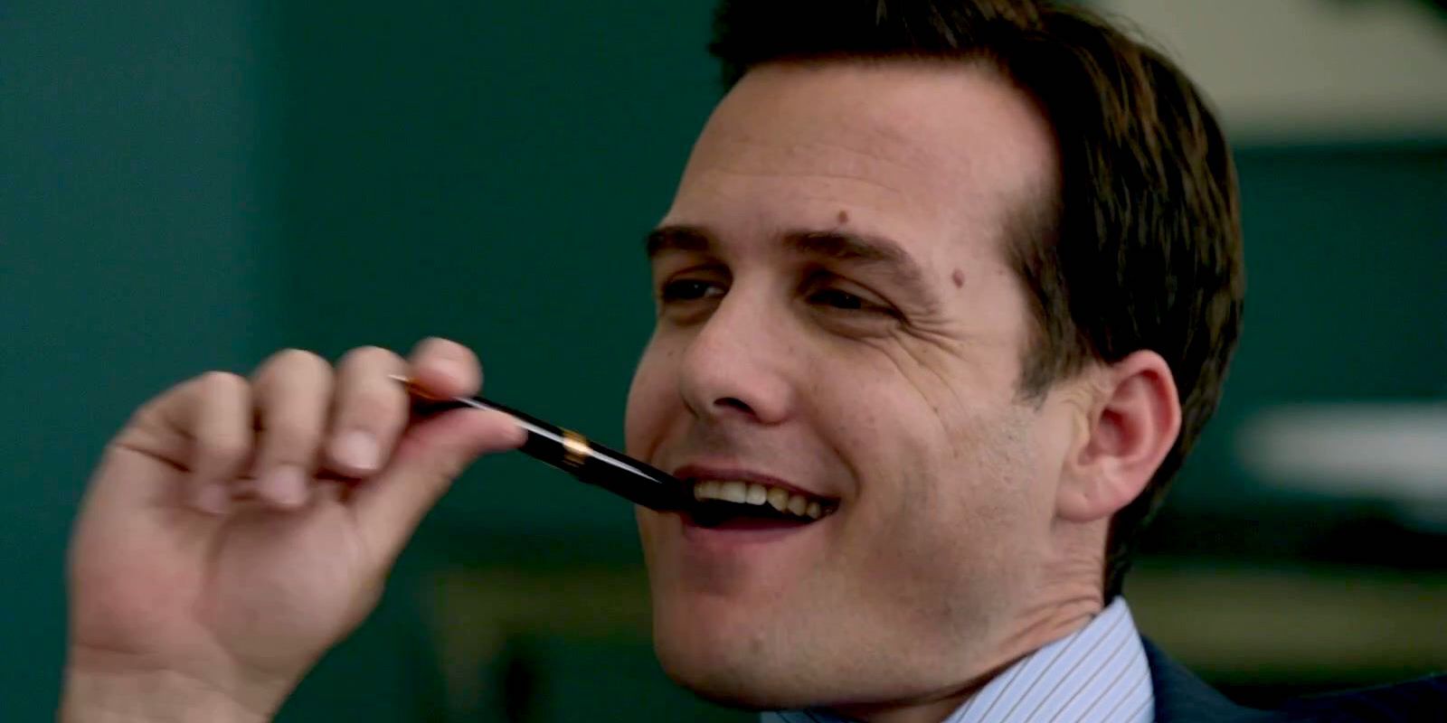 Lawyer Smiling with a Pen in His Mouth in Suits Season 1