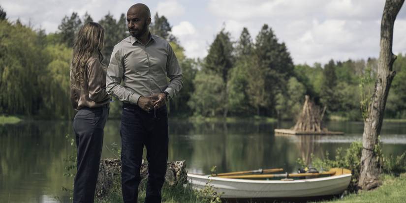 Christian and Leonora stand near a lake in Loving Adults 