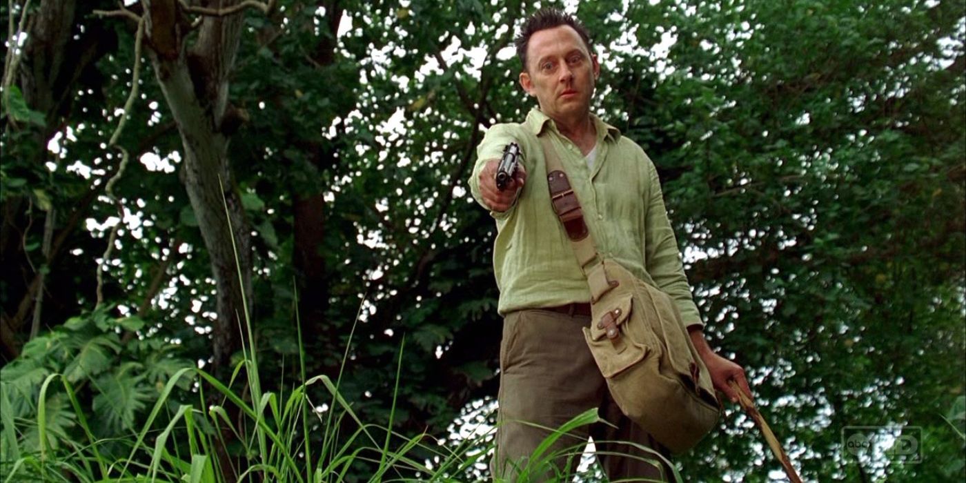 Ben Linus points a gun at someone in Lost.