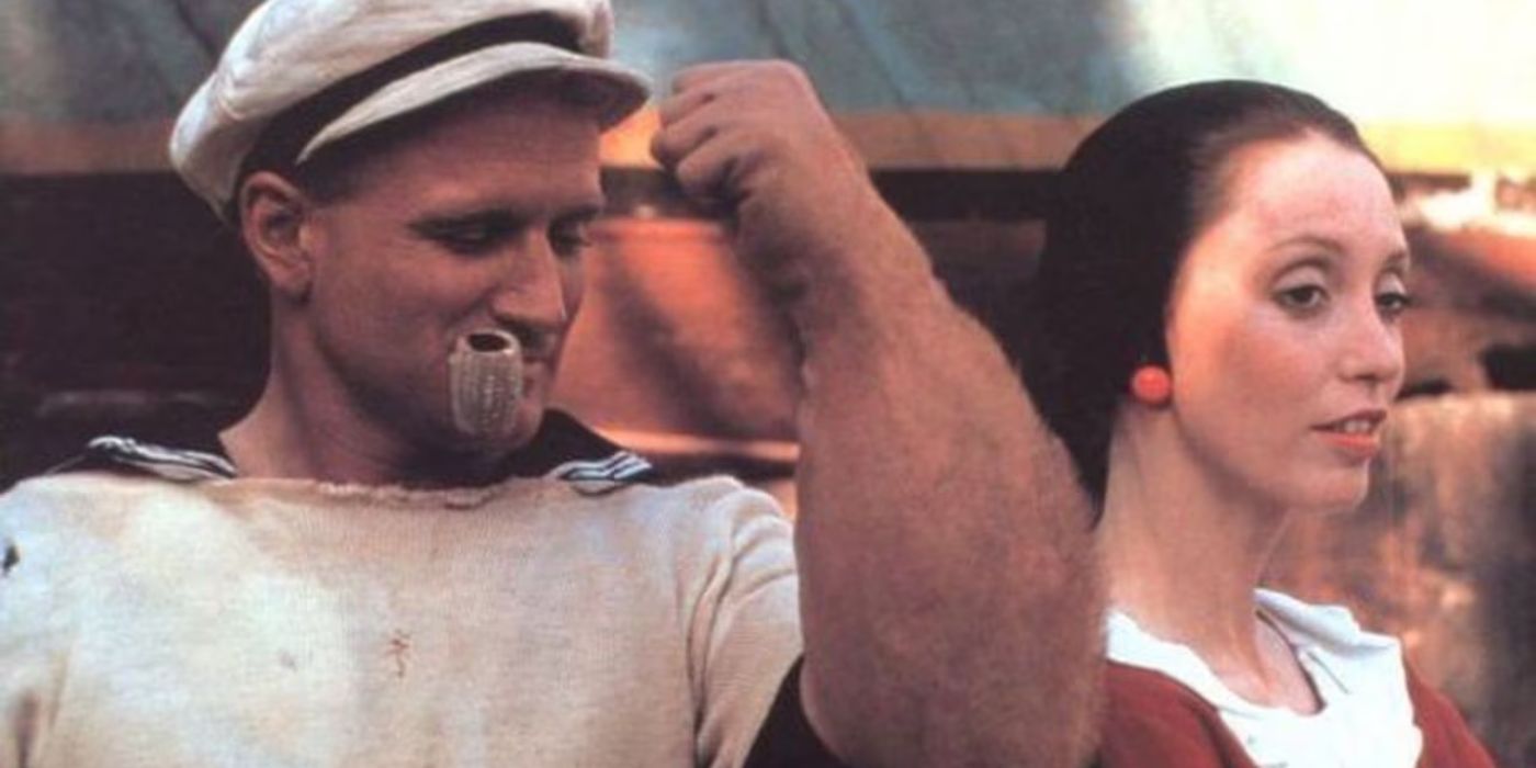 Popeye (Robin Williams) flexing in front of Olive (Shelley Duvall) in Popeye