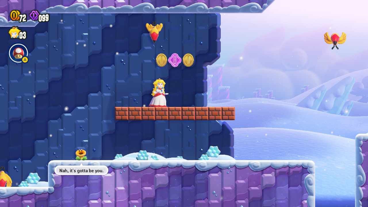Princess Peach about to be attacked by a bird in a snowy level of Super Mario Bros. Wonder.