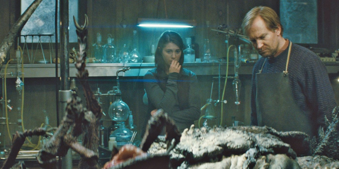 Mary Elizabeth Winstead and a male scientist looking at a mutated alien in The Thing prequel.