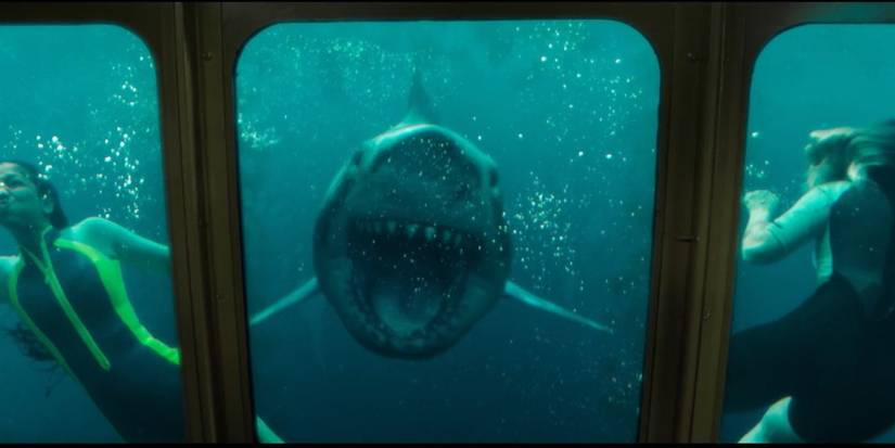 Mia and Sasha outide a glass bottom boat when a shark attacks in 47 Meters Down Uncaged.