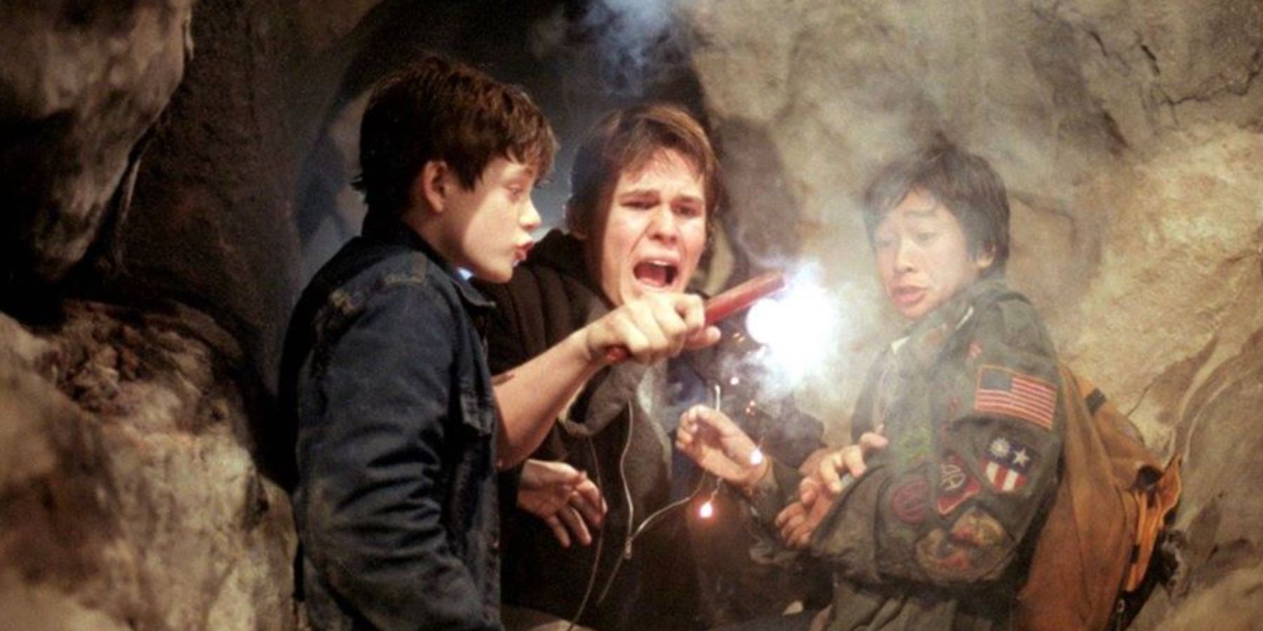 Mikey, Brand, and Data with an explosive candle in The Goonies
