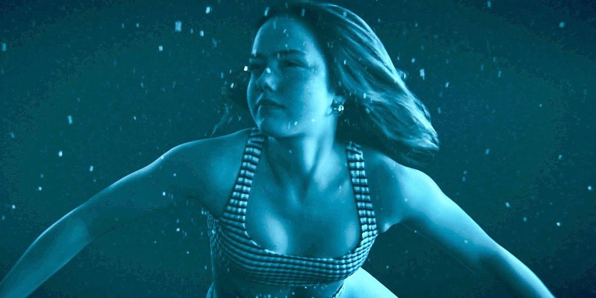 Girl swimming under water in a bathing suit in Night Swim