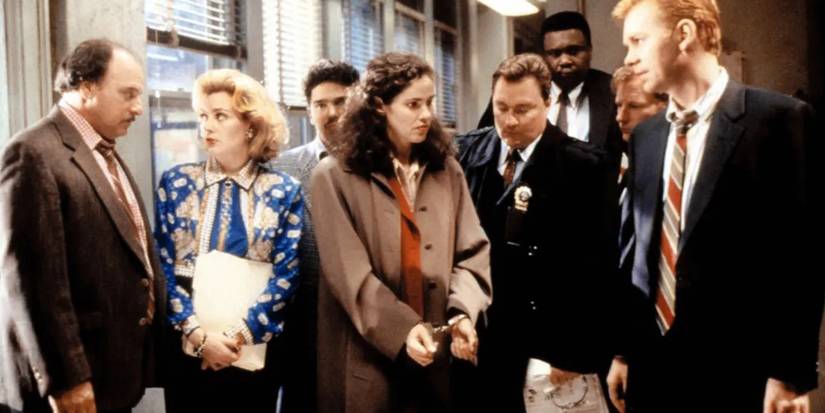 Still from NYPD Blue featuring the entire cast in suits