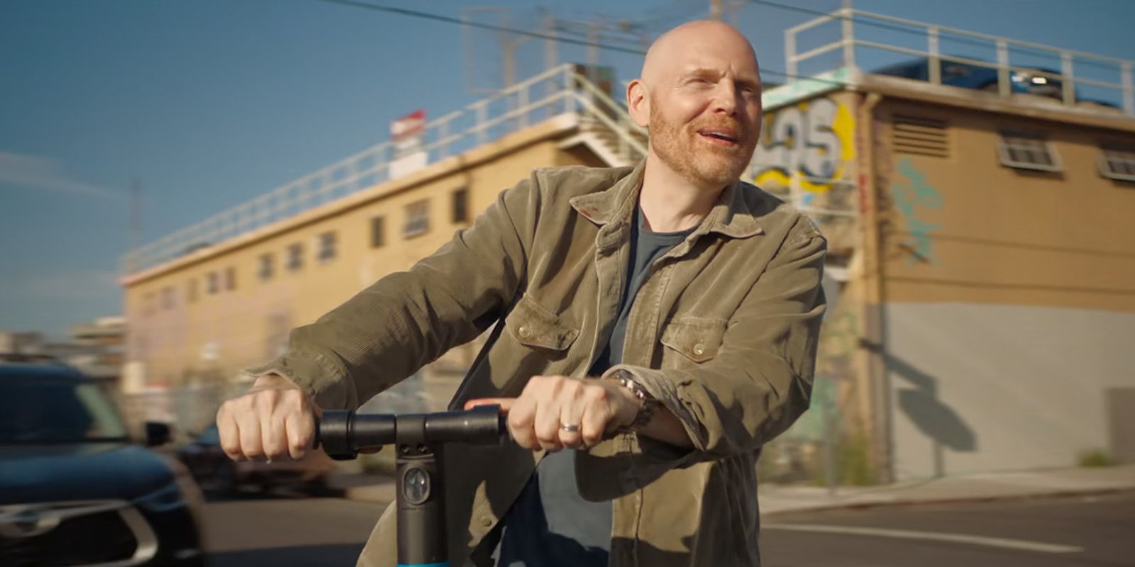 Jack rides on an electric scooter in Old Dads.