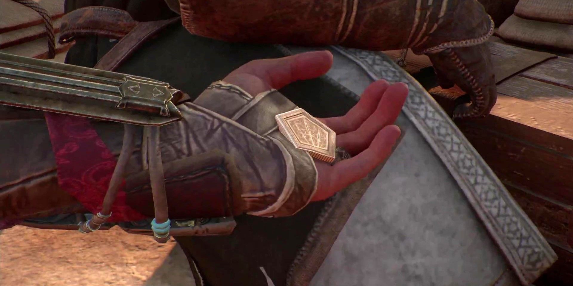 Basim holding a Power Token in Assassin&rsquo;s Creed Mirage