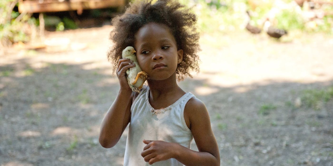 Quvenzhané Wallis leaning a chick next to her face in Beasts of the Southern Wild