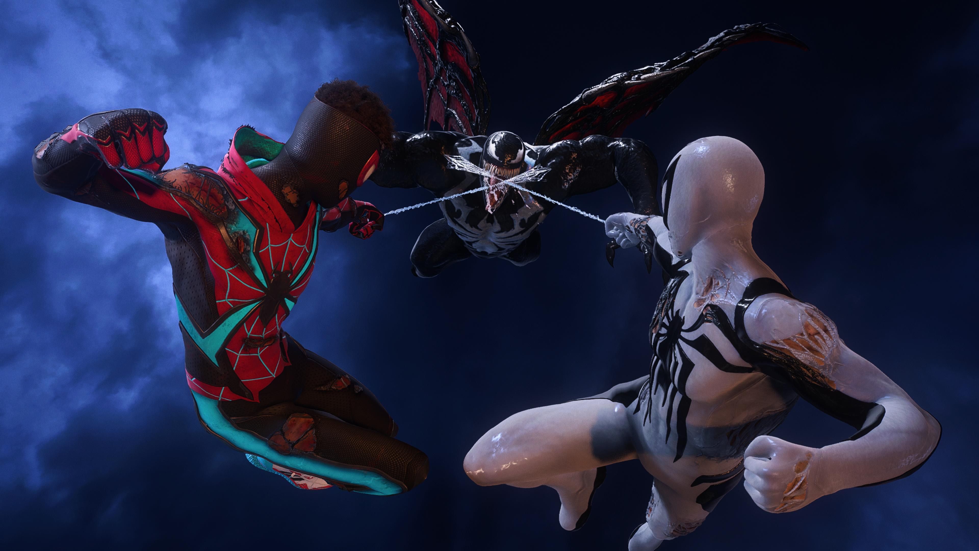 Peter Parker in a white and black suit, and Miles Morales in a black, red, and blue suit, both with a web attached to Venom in midair above, ready to deliver a punch with their free hands.