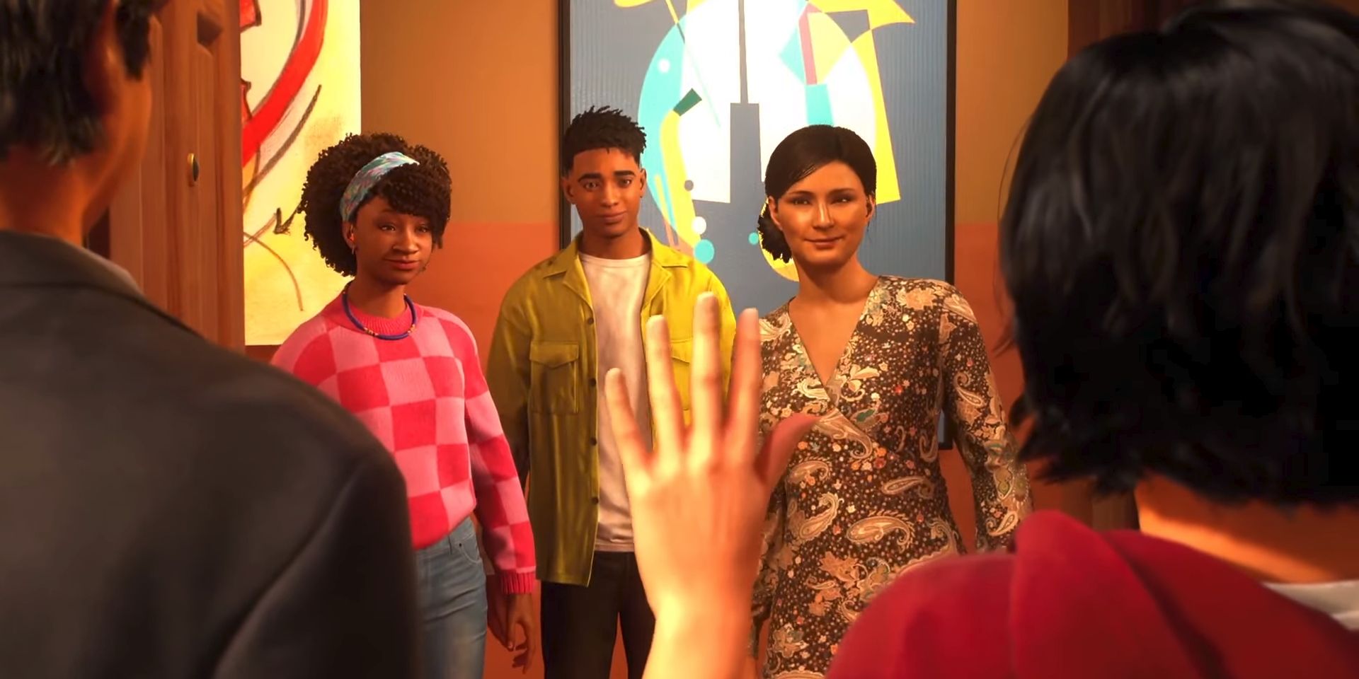 Hailey, Miles, and Rio look on through an apartment doorway as Cindy Moon, seen from behind, waves hello in a screenshot from Marvel's Spider-Man 2.